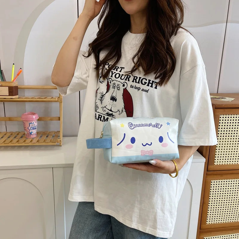Person holding a small pouch with a cartoon design in a casual setting