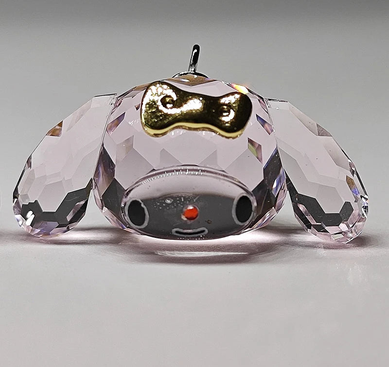 Crystal dog figurine with a gold collar on a gray background