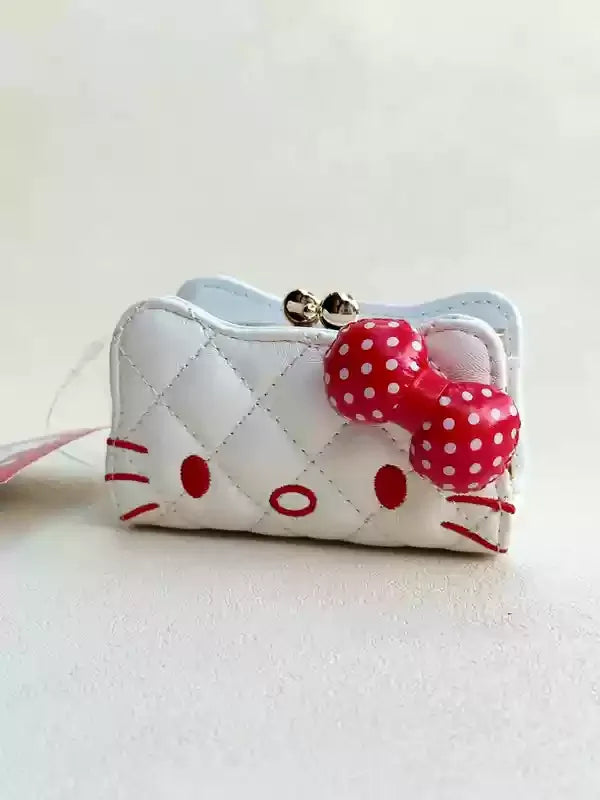 White quilted pouch with red polka dot bow on a light gray background
