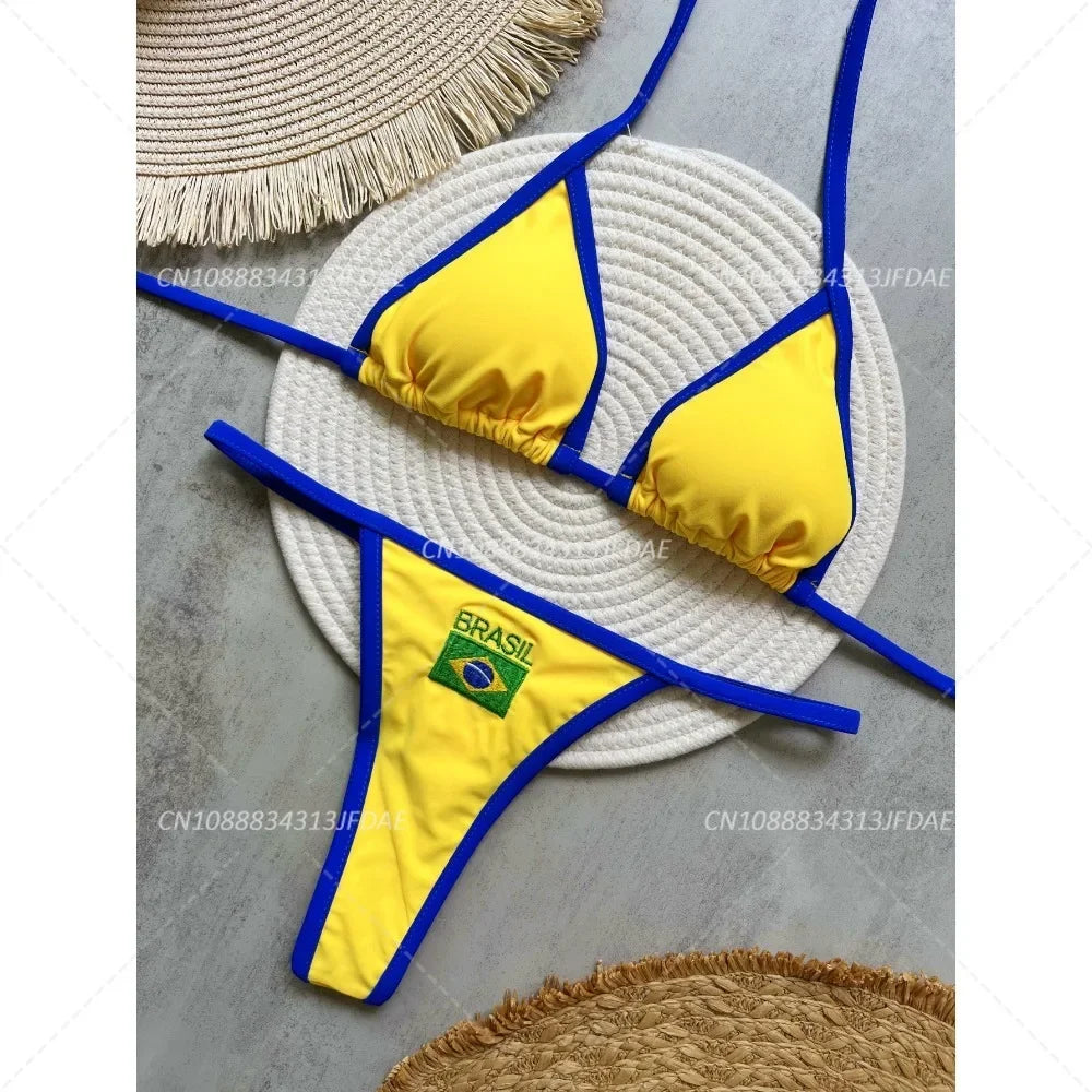 Yellow bikini with blue straps on a gray surface with woven hats.