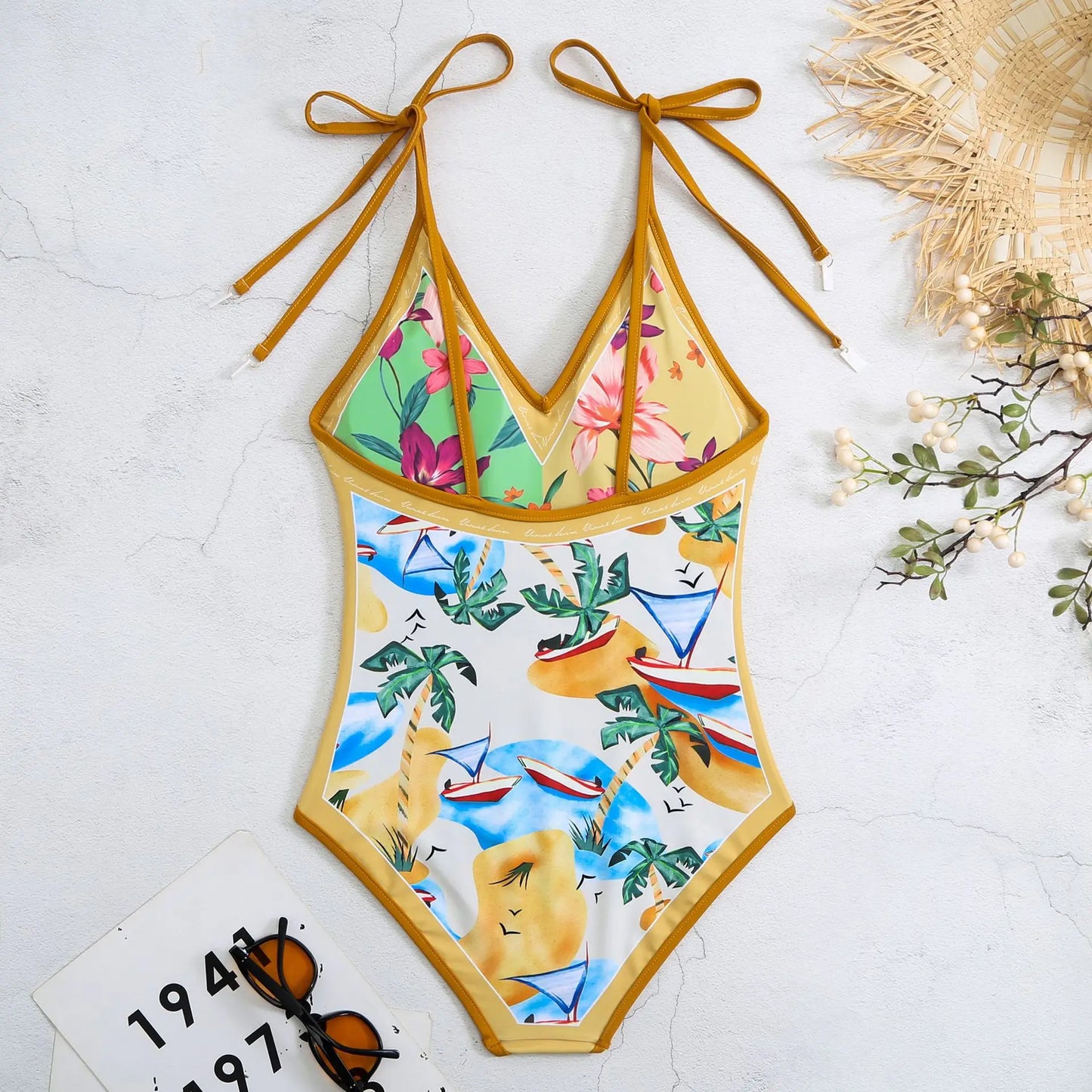 Colorful swimsuit with tropical patterns on a light background