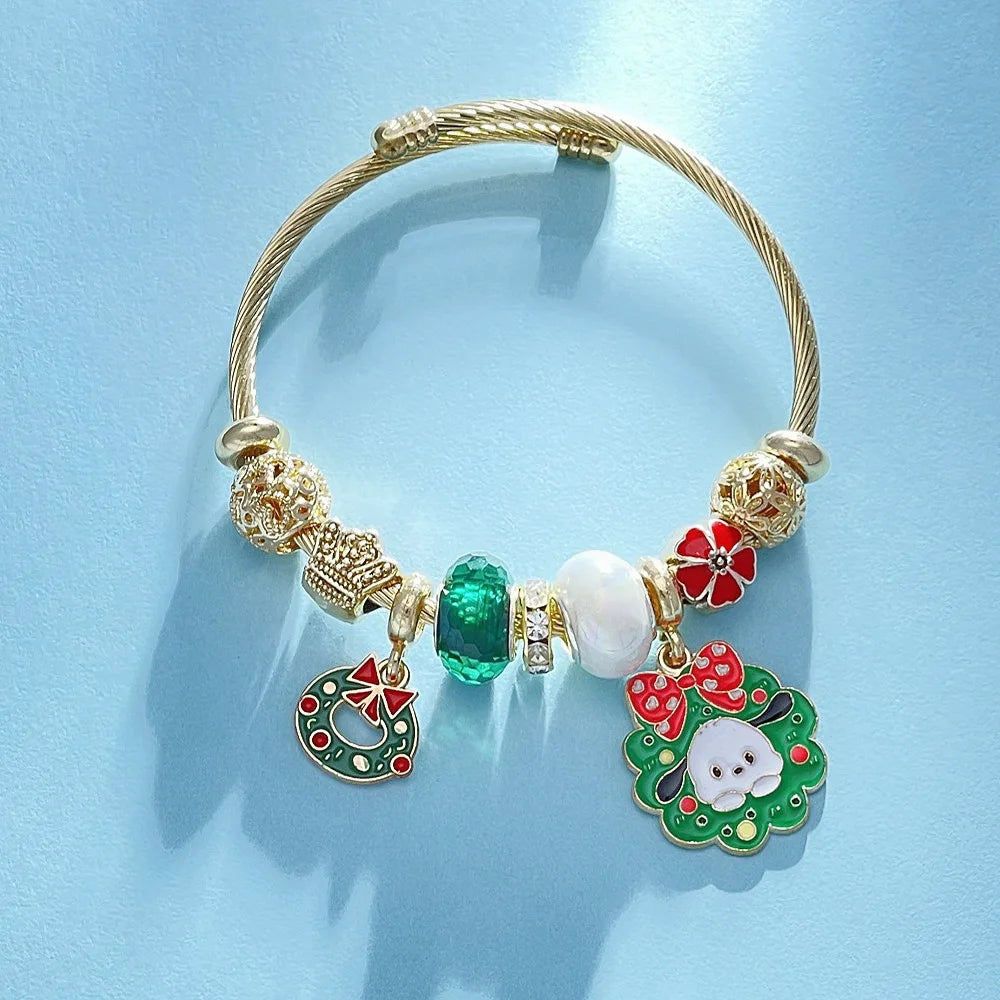 Gold bracelet with colorful charms on a light blue background