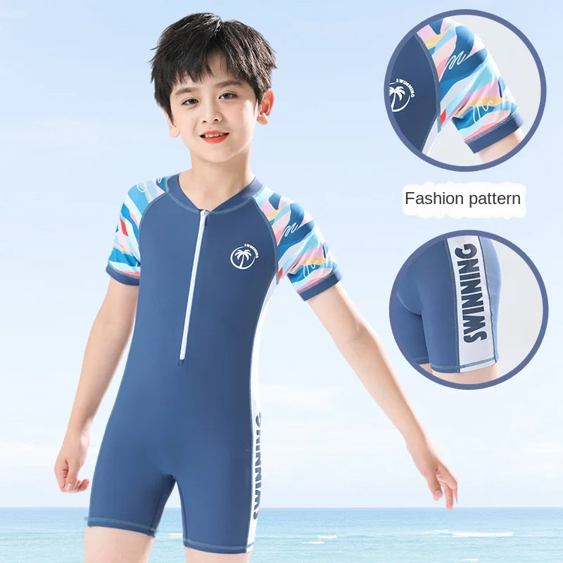 Child wearing a blue swimsuit with colorful patterns on a light blue background