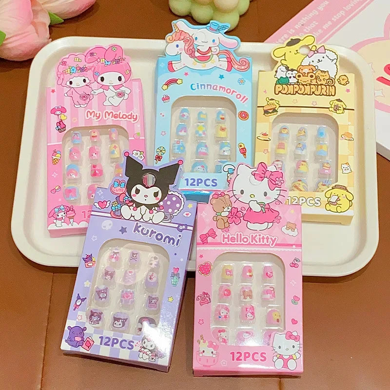 Cartoon character-themed nail art stickers in colorful packaging on a wooden surface.