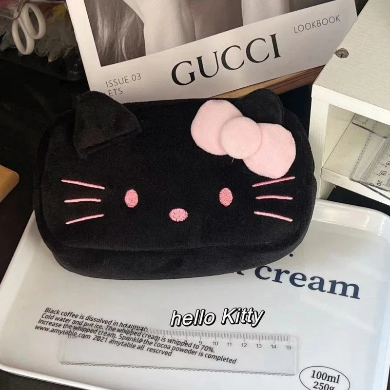 Black Hello Kitty pouch on a Gucci magazine with 'hello Kitty' branding.