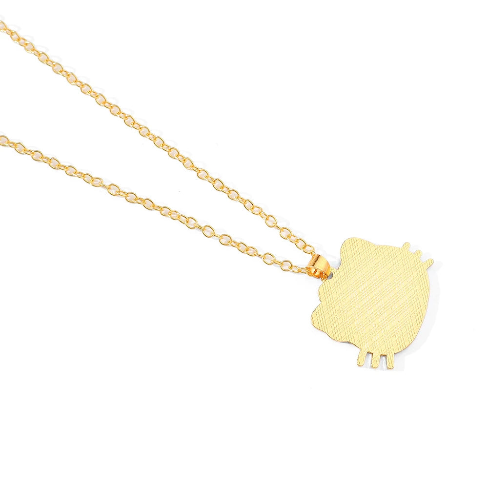 Gold owl-shaped pendant on a chain against a white background