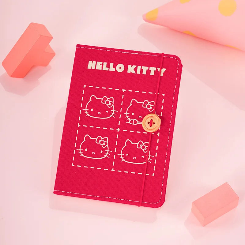 Red 'Hello Kitty' notebook and cover on a pink background
