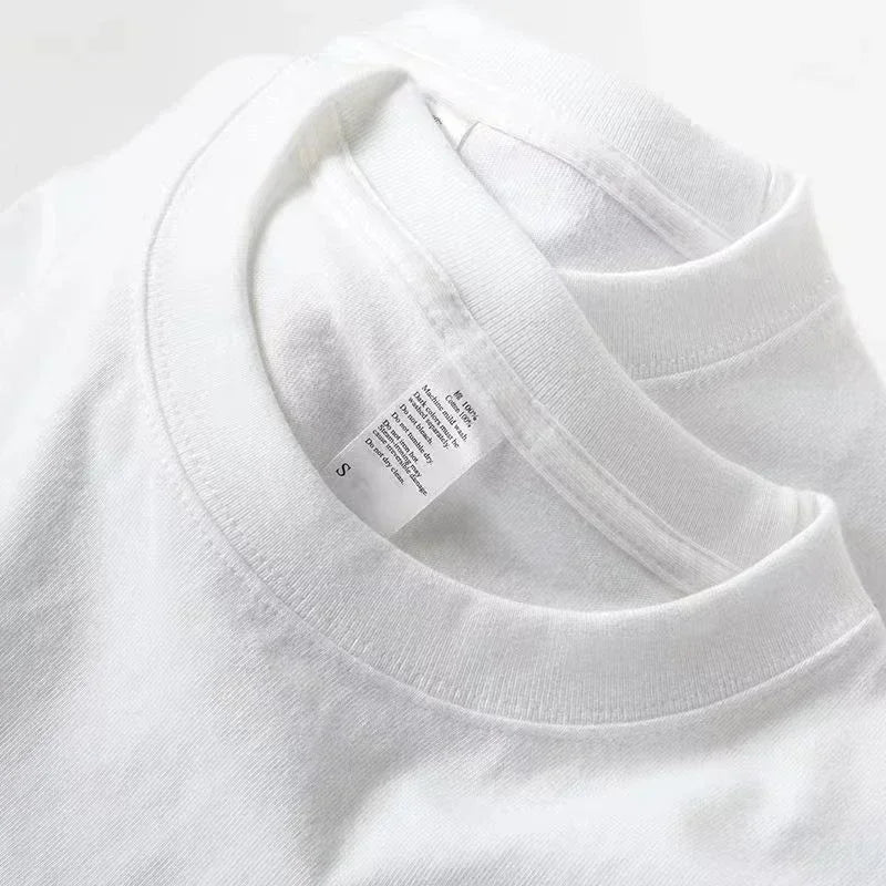 Close-up of a white t-shirt with a tag on a light gray background