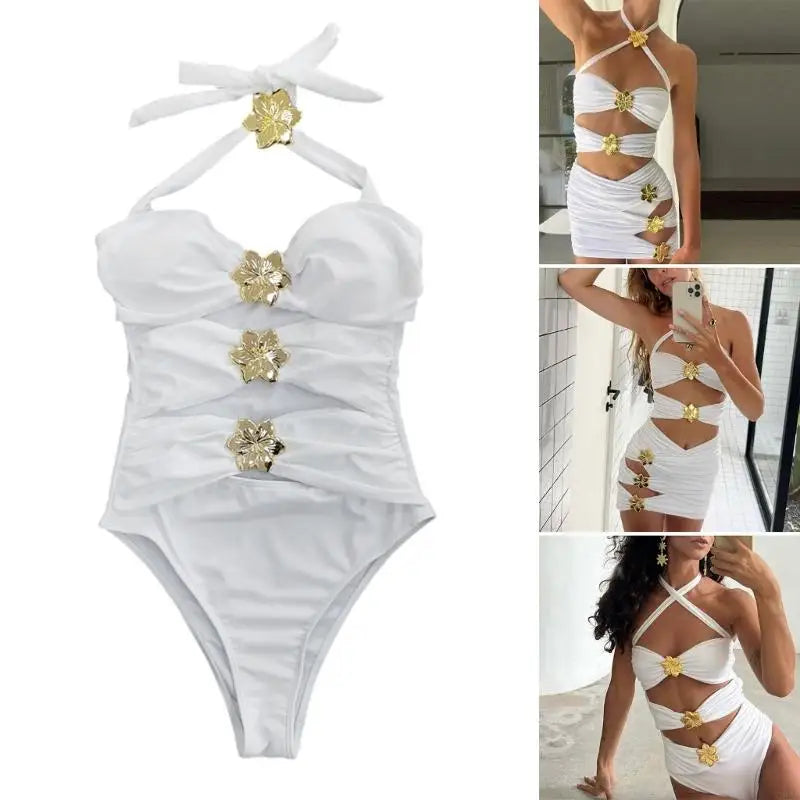 White swimsuit with gold floral embellishments on a white background