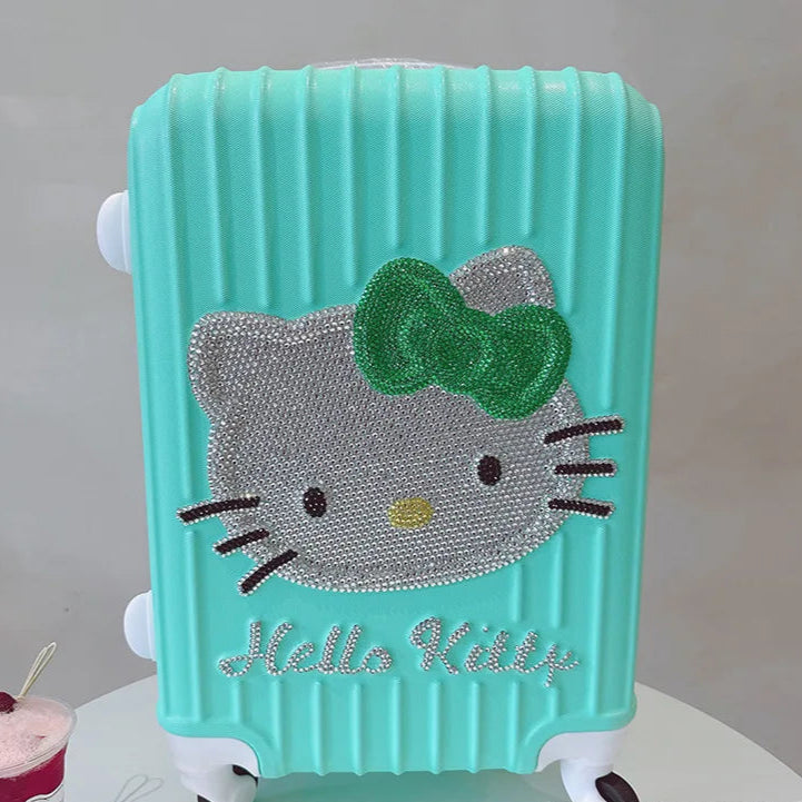 Turquoise suitcase with Hello Kitty design on a white surface