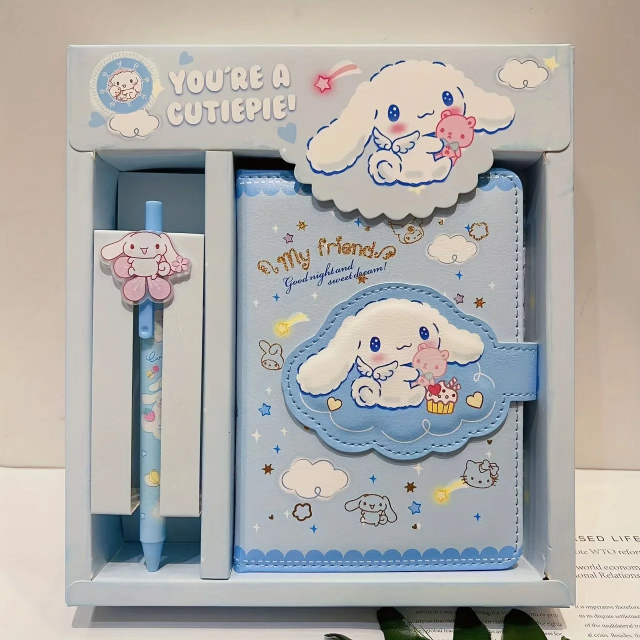 Cute stationery set with a cartoon character in a box, featuring a pen, notebook, and stickers.