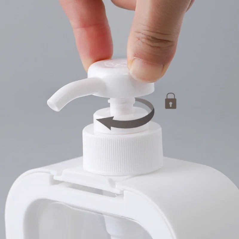 Hand holding a white pump bottle with a gray background