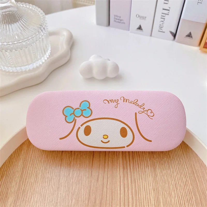 Pink glasses case with cartoon character design on a wooden surface