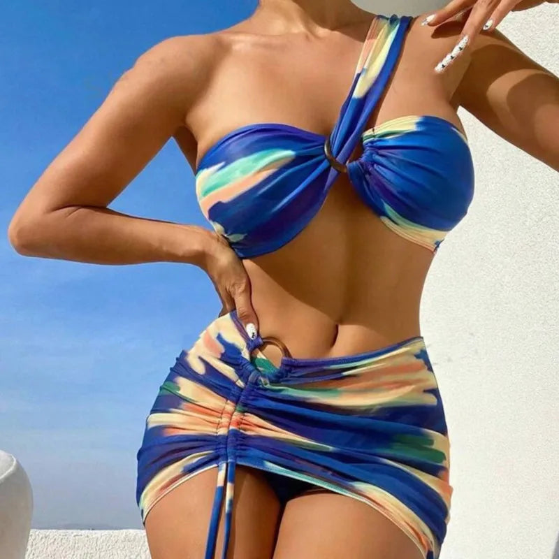 Woman wearing a colorful bikini with a blue sky background