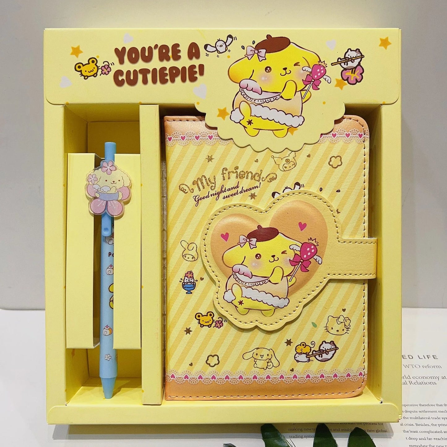 Yellow stationery set with cartoon character, pen, and notebook in a box.