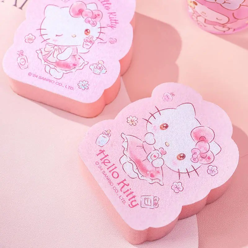 Heart-shaped pink kitchen sponge with Hello Kitty design on a light pink background