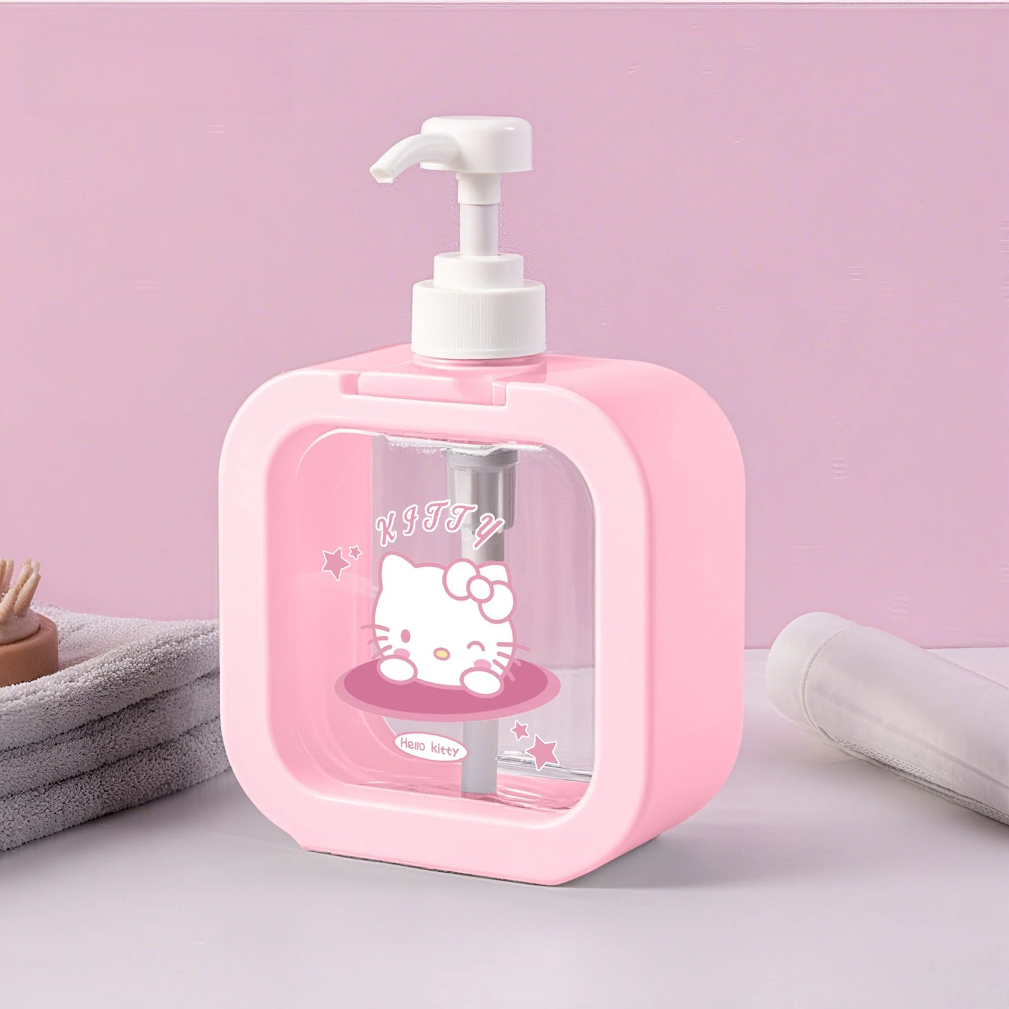 Pink soap dispenser with Hello Kitty design on a pink background