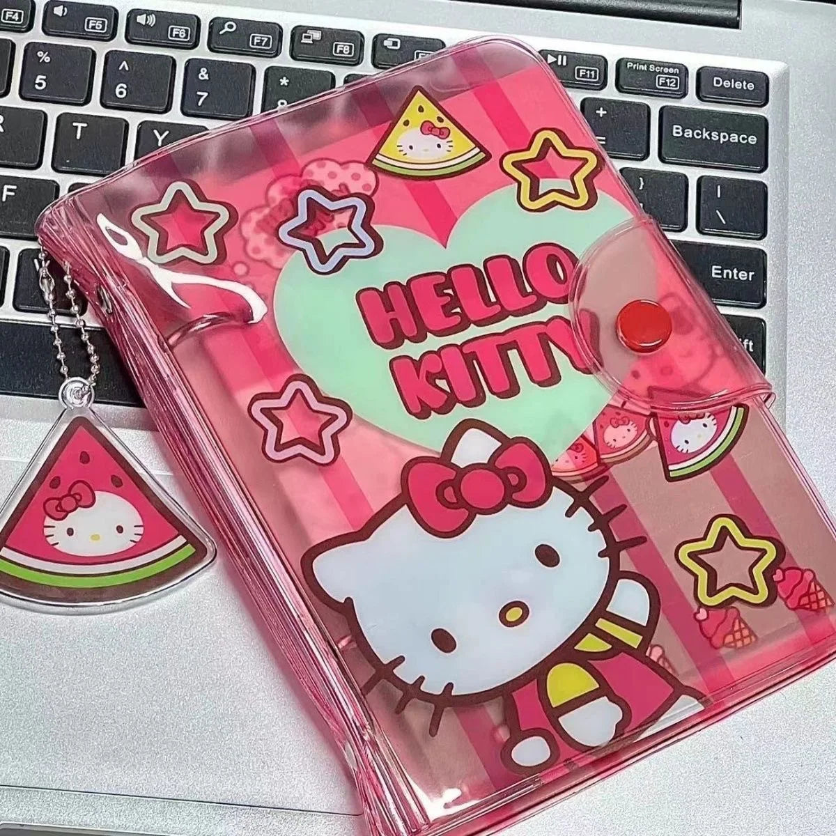 Hello Kitty transparent pouch with watermelon design on a laptop keyboard
