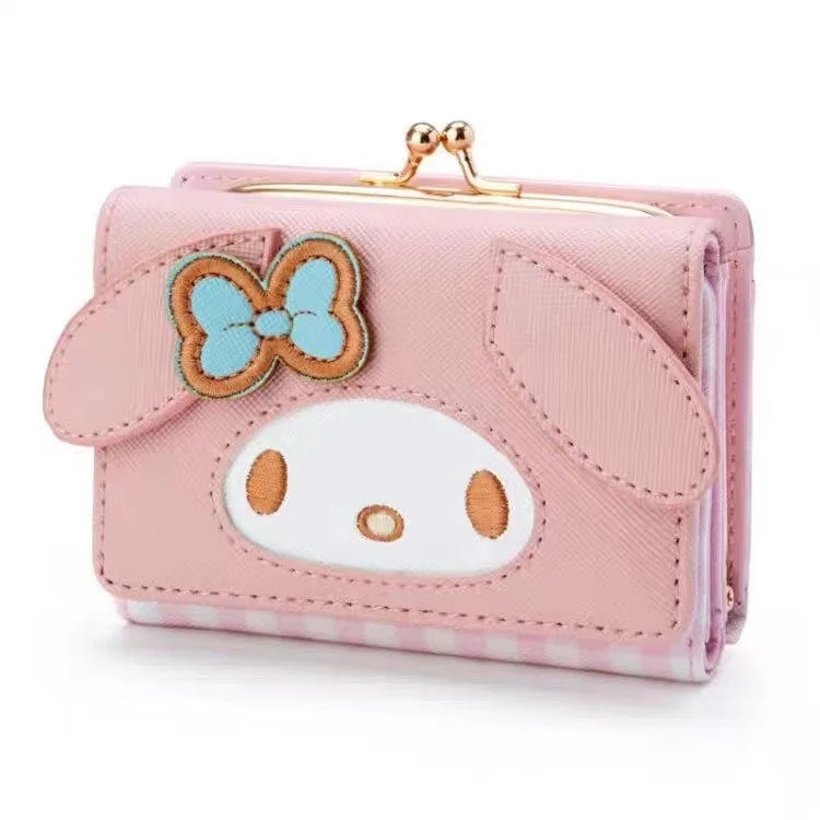 Pink wallet with cartoon character and bow design on a white background