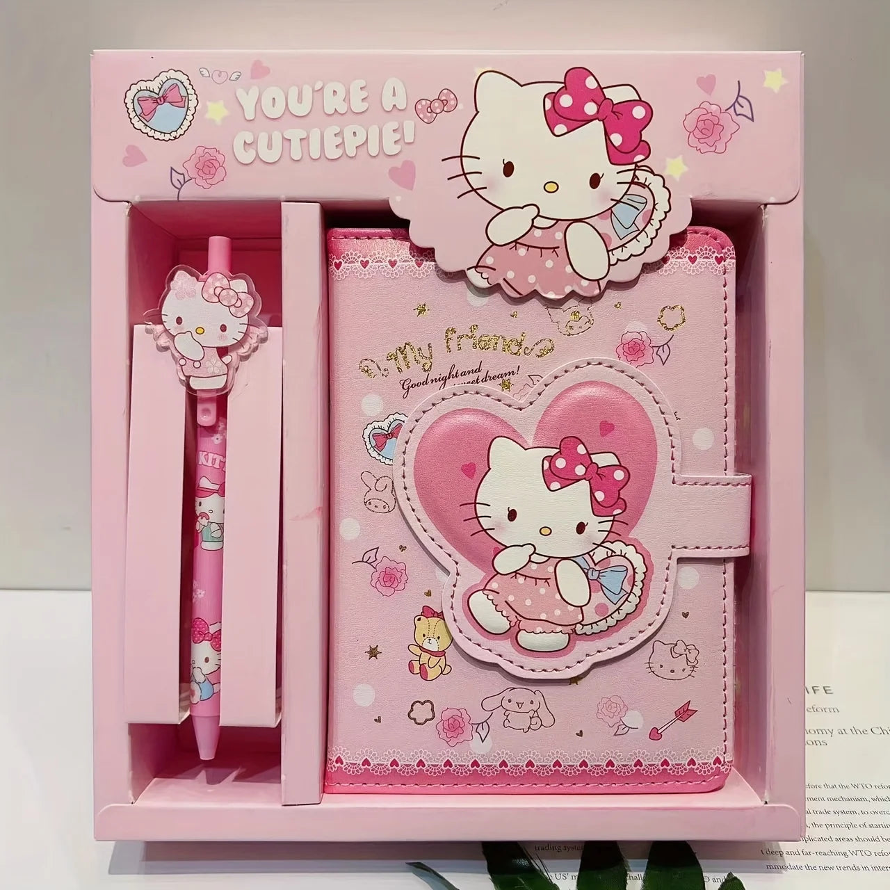 Hello Kitty notebook and pen set in a pink box with decorative elements.