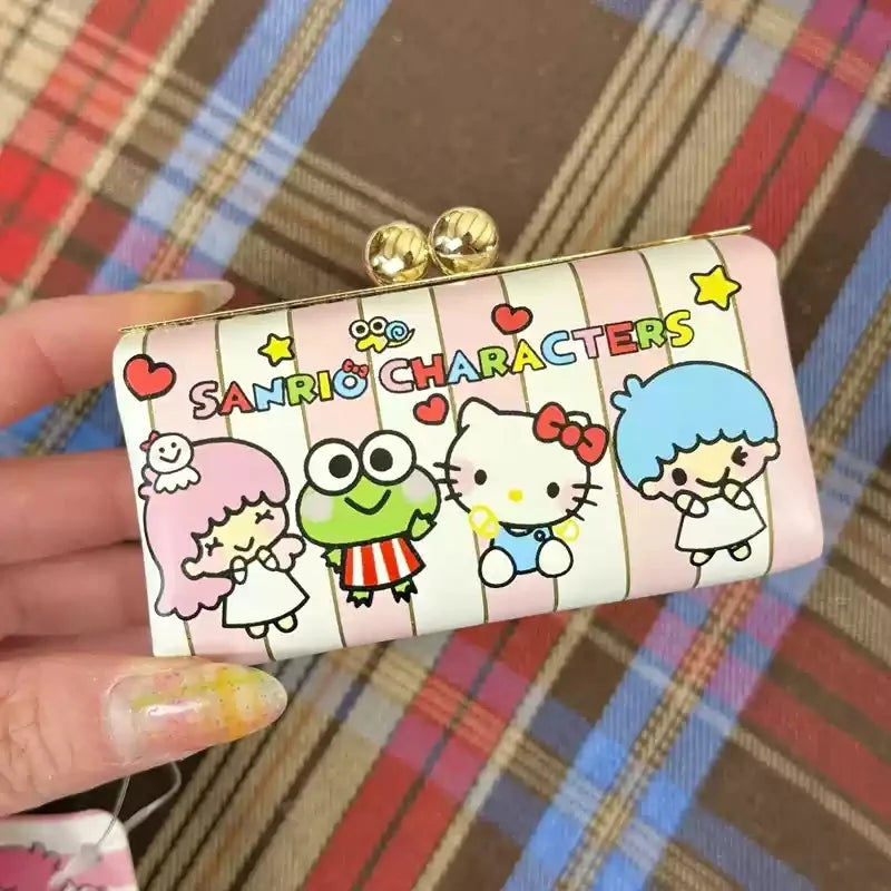 Hand holding a rectangular pouch with cartoon characters and 'Sanrio Characters' text on a plaid background.