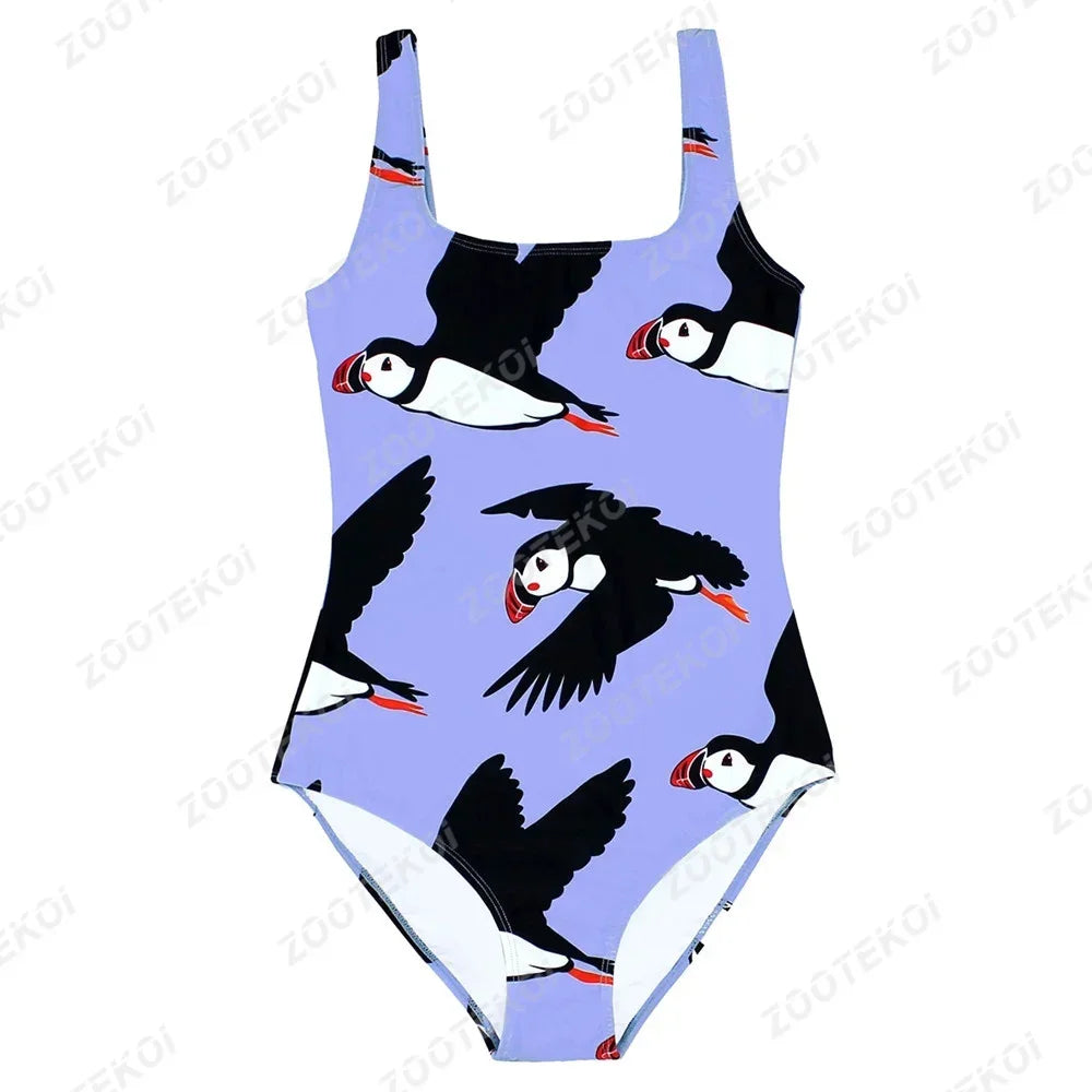 One-piece swimsuit with puffin pattern on a light purple background