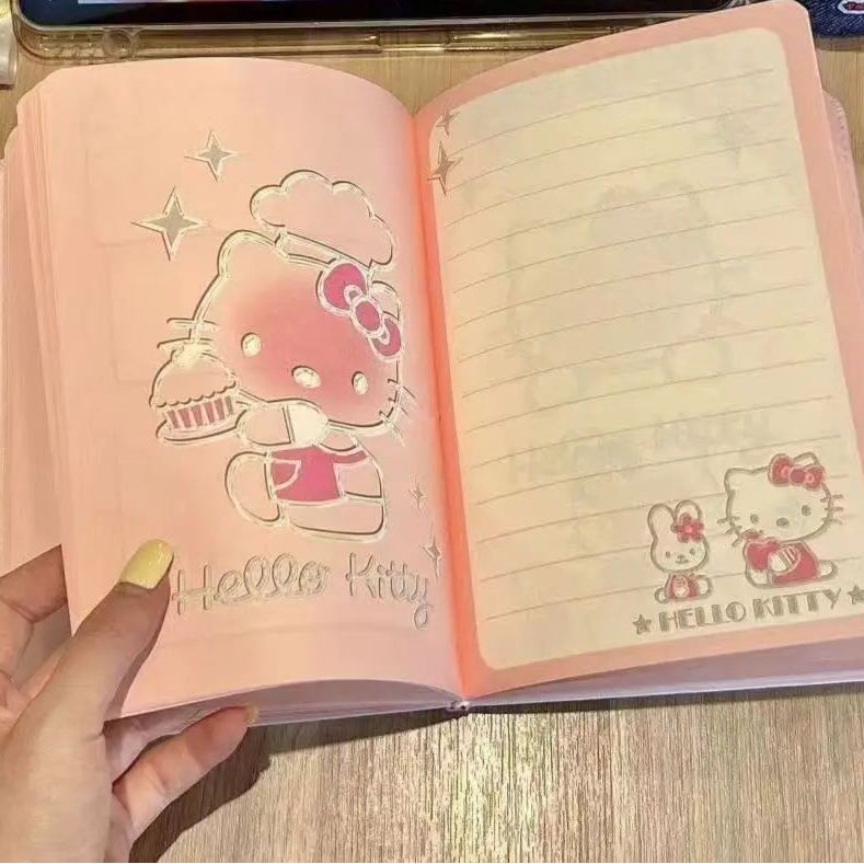 Pink Hello Kitty notebook on a wooden surface, cartoon character in the background.