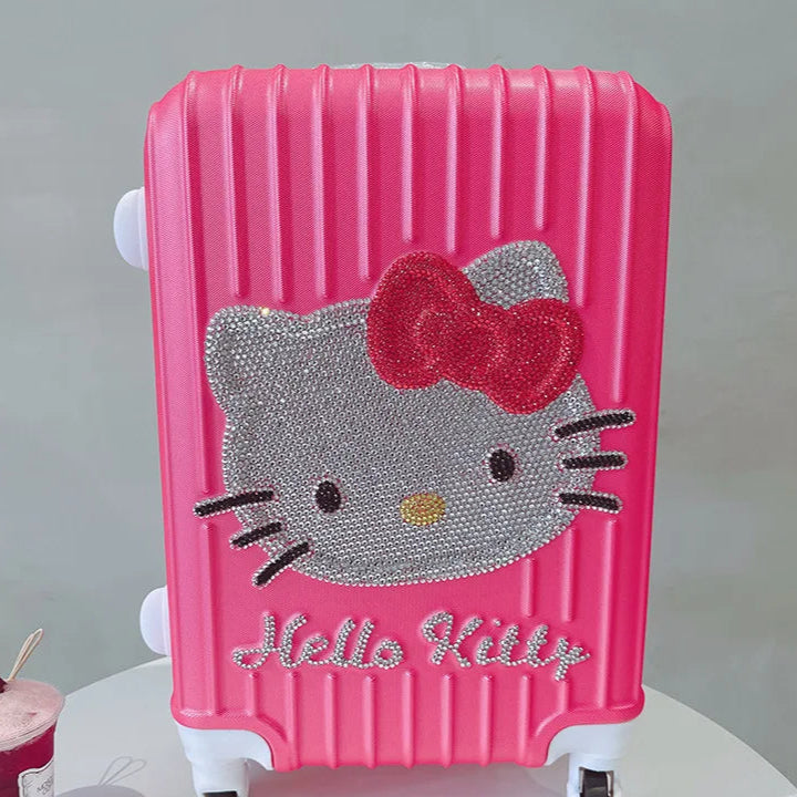 Pink suitcase with Hello Kitty design on a white surface