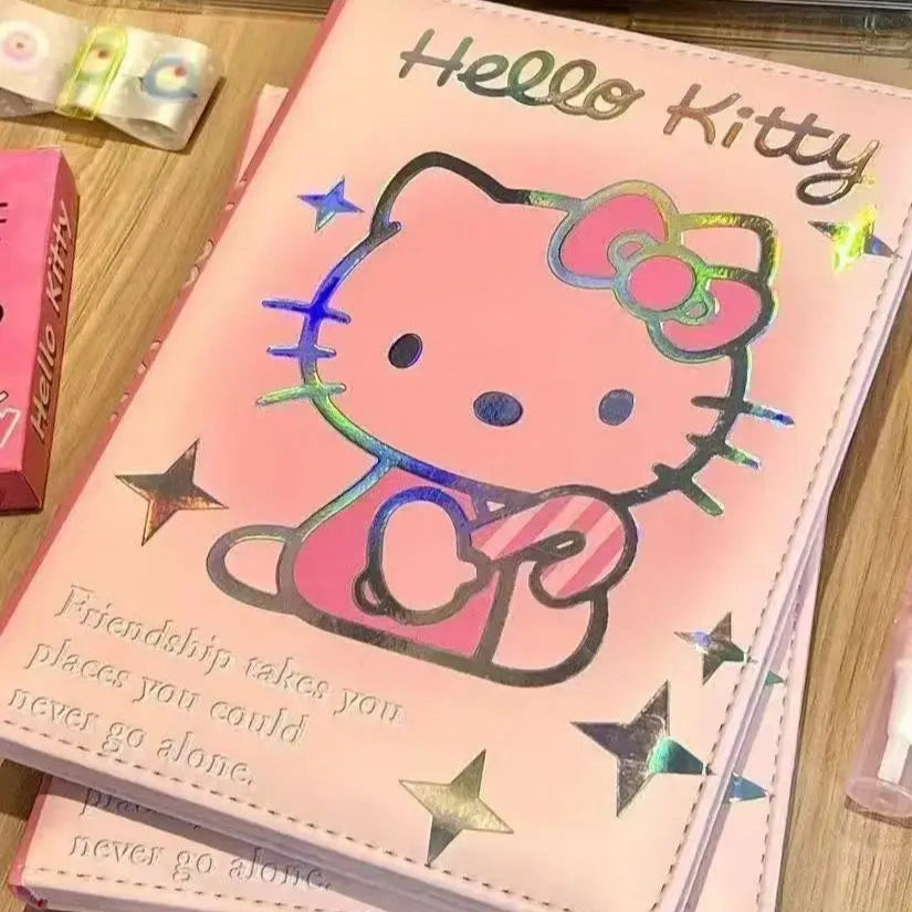 Hello Kitty notebook with a pink cover on a wooden surface
