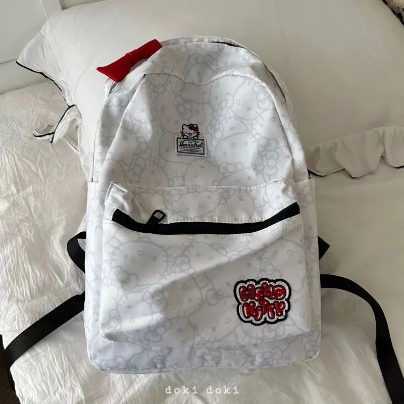 White backpack with black straps on a white surface