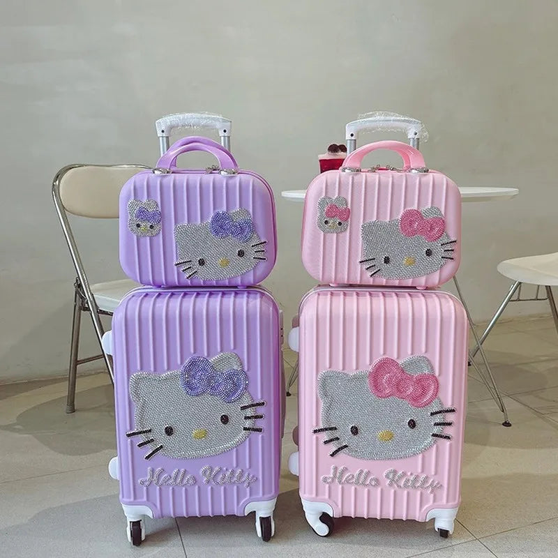 Set of pink and purple 'Hello Kitty' suitcases on a neutral background