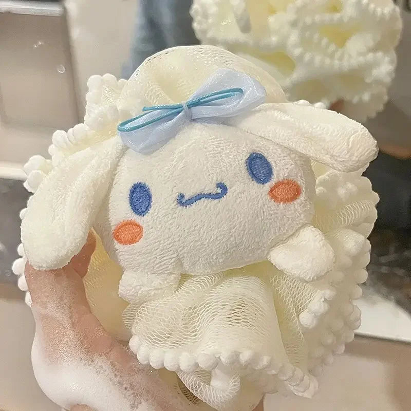 White kitty bath scrub plush toy with a blue bow on a coral-like background