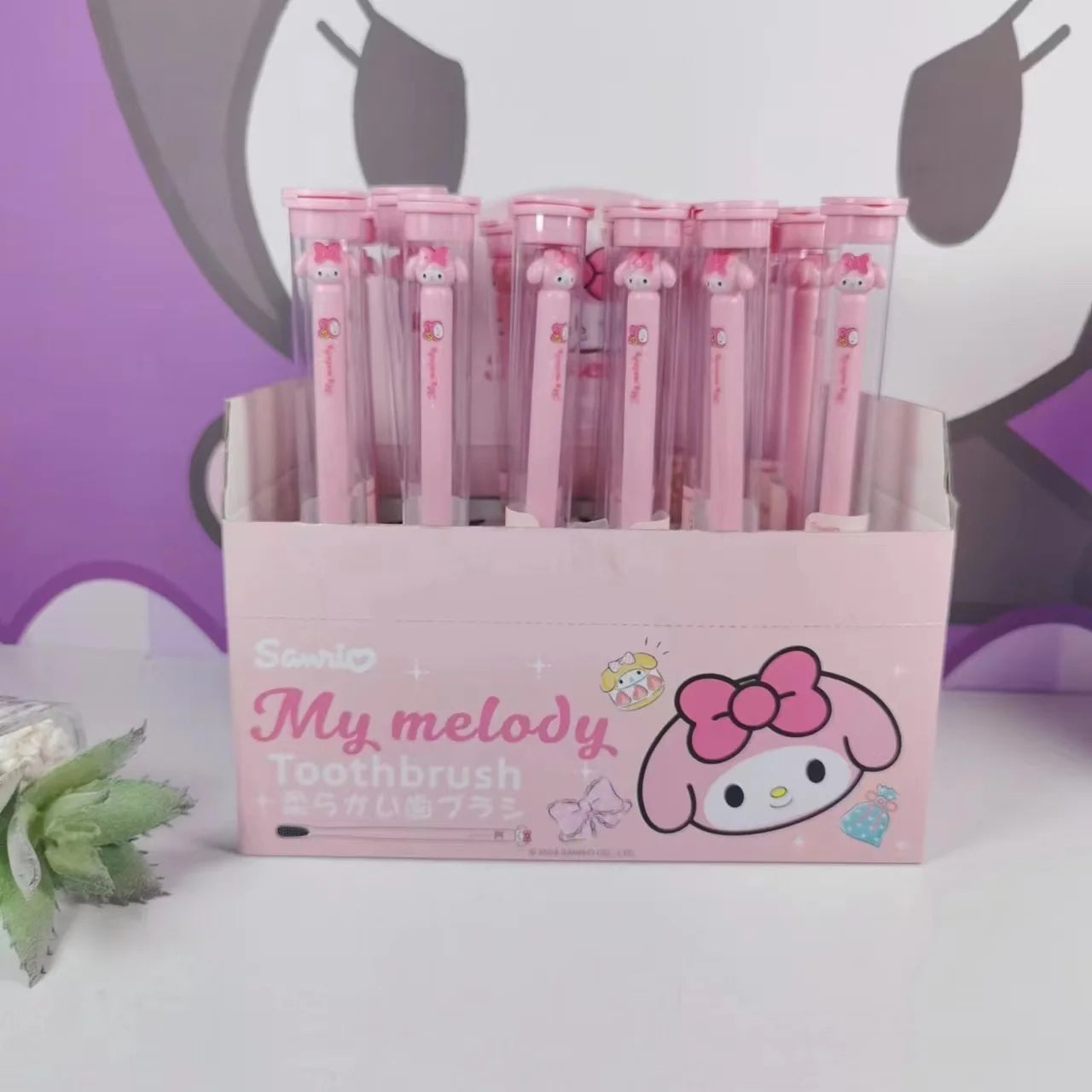 Box of Sanrio My Melody toothbrushes with a pink background
