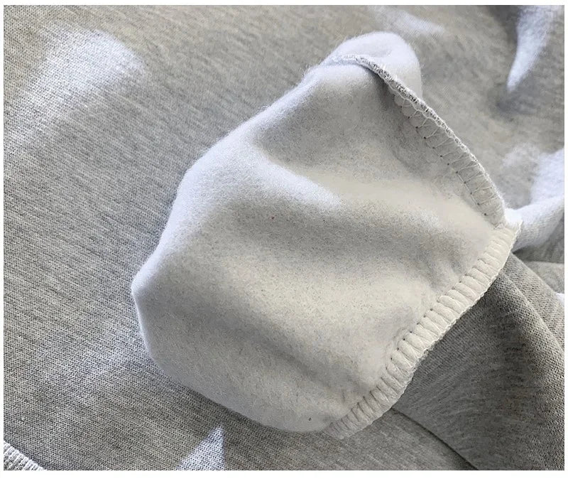 Close-up of a gray fabric with a white border on a textured surface