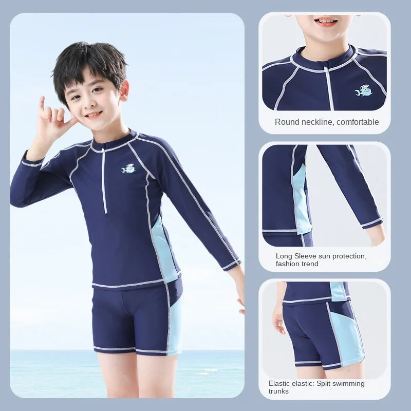 Child wearing a navy blue long-sleeve swimsuit with split swim pants, set against a light blue background.