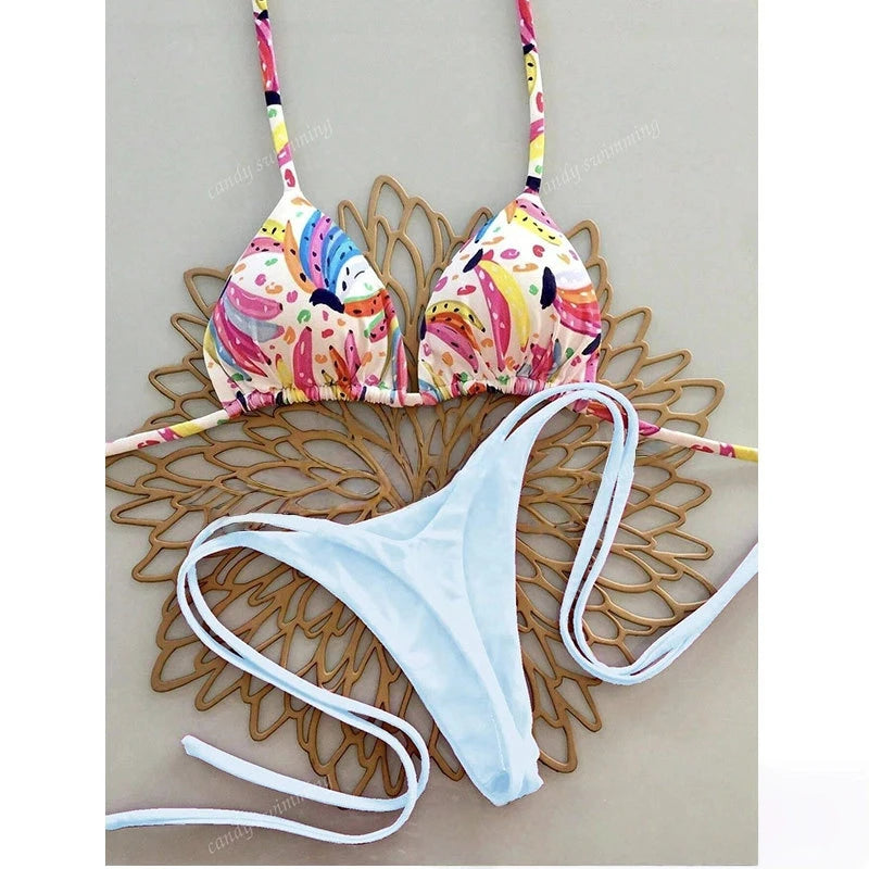 Colorful bikini top and white bottoms on a decorative wooden surface