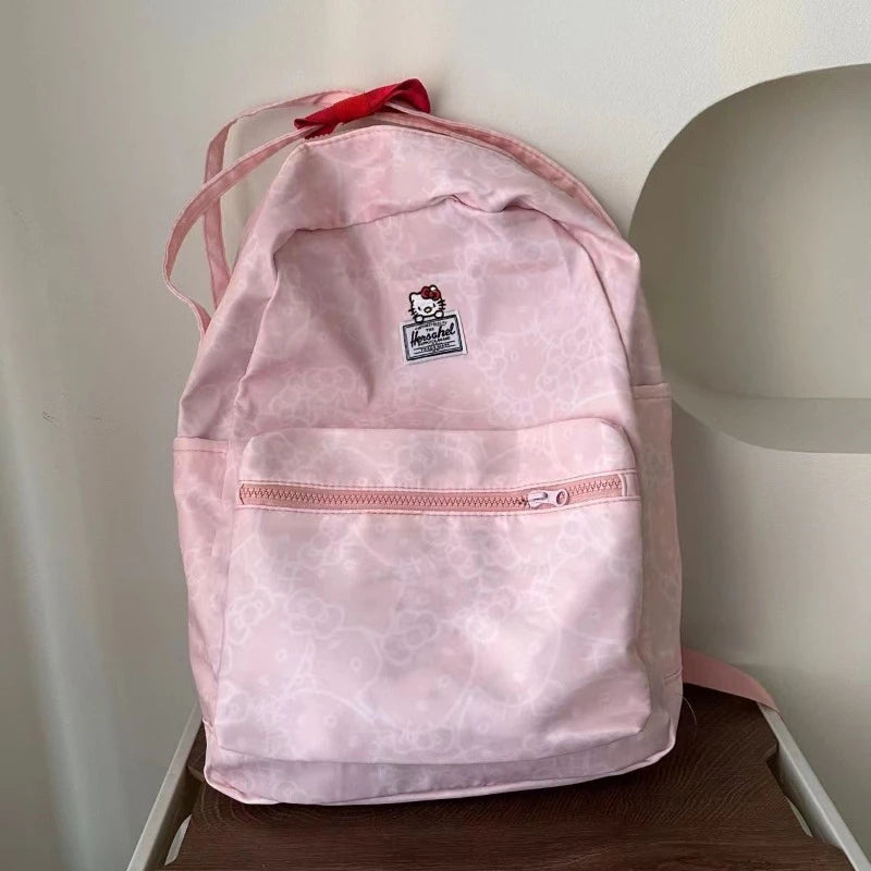 Pink backpack with a logo on a wooden surface