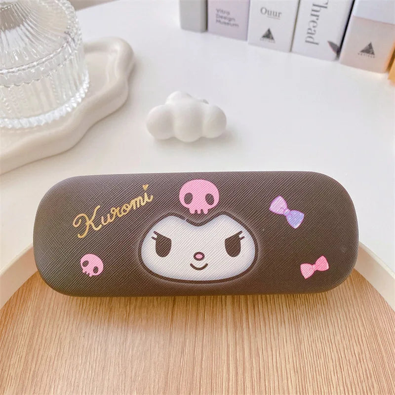 Brown case with a cartoon face and 'Kuromi' branding on a wooden surface.