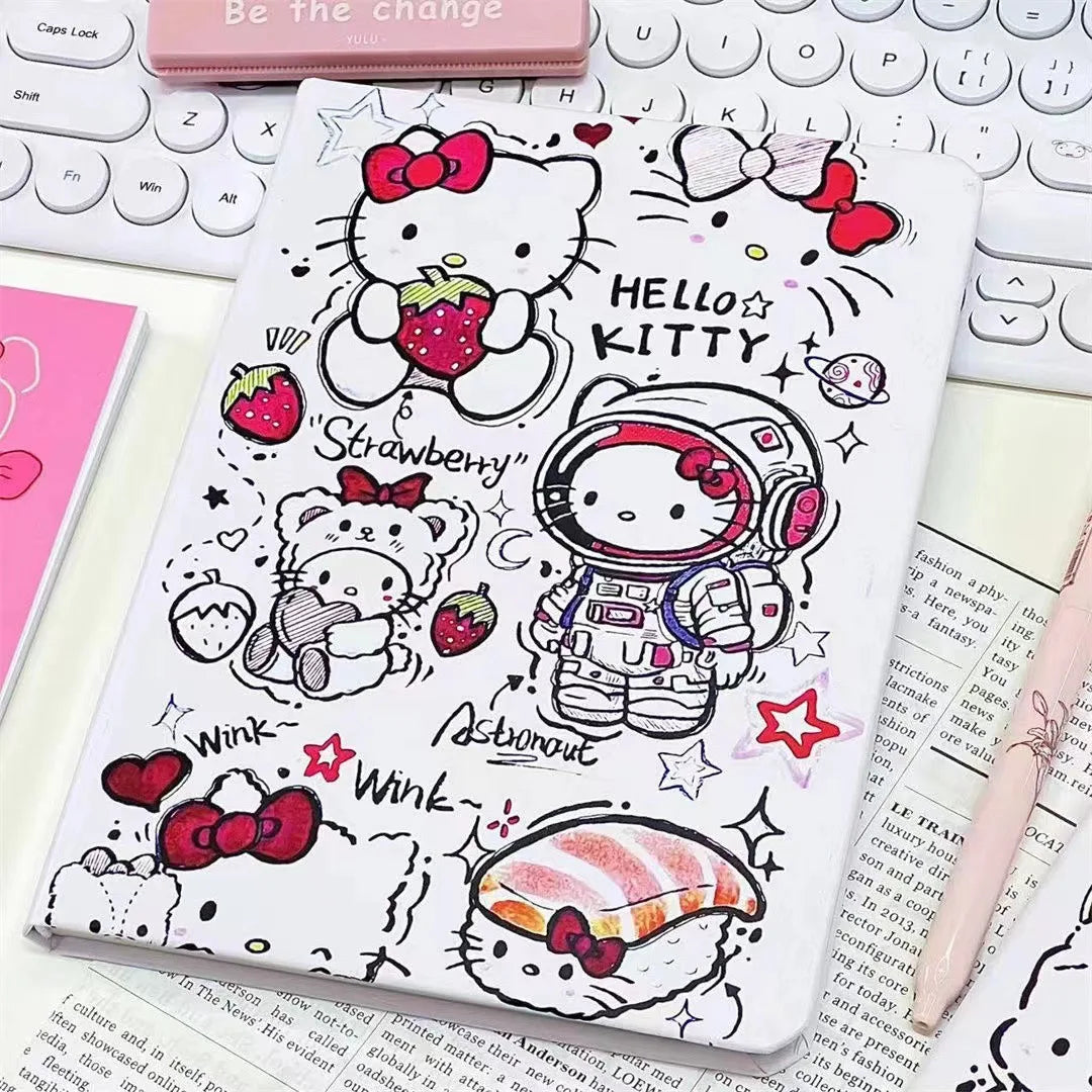 Notebook with Hello Kitty illustrations on a desk with a keyboard and pen.