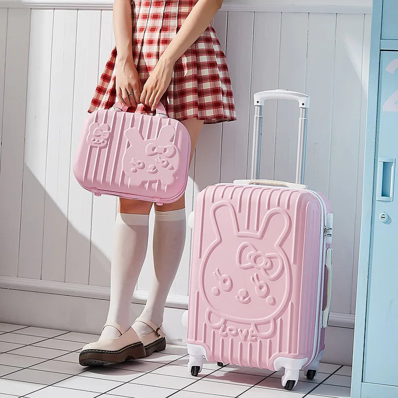 Person holding a pink suitcase with a bunny design in a room.
