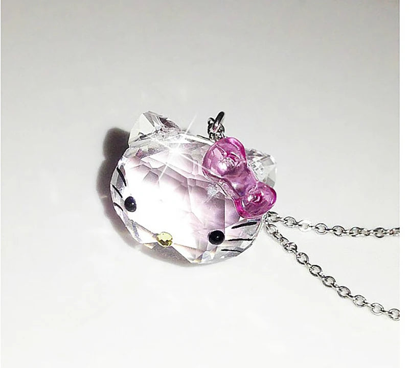 Crystal pendant with pink bow on a white background