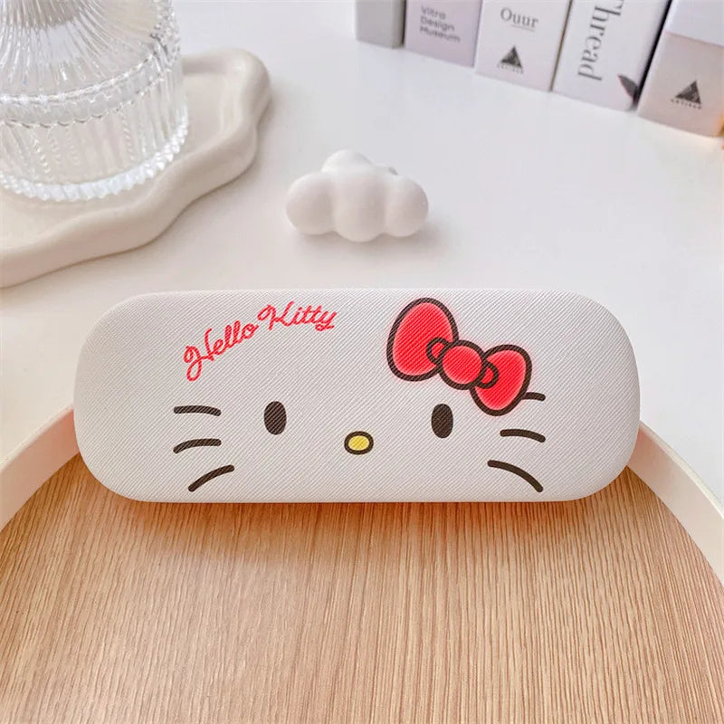 White Hello Kitty glasses case with red bow on a wooden surface