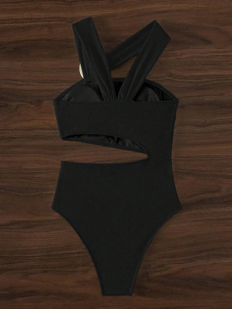 Black swimsuit on a wooden surface