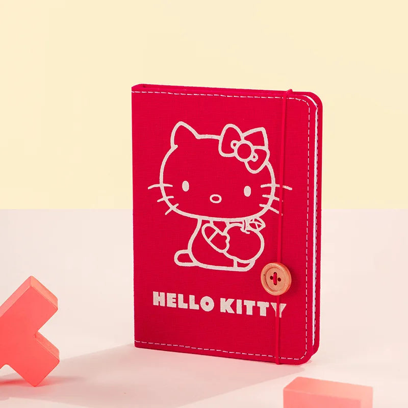 Red notebook with Hello Kitty design on a light yellow background