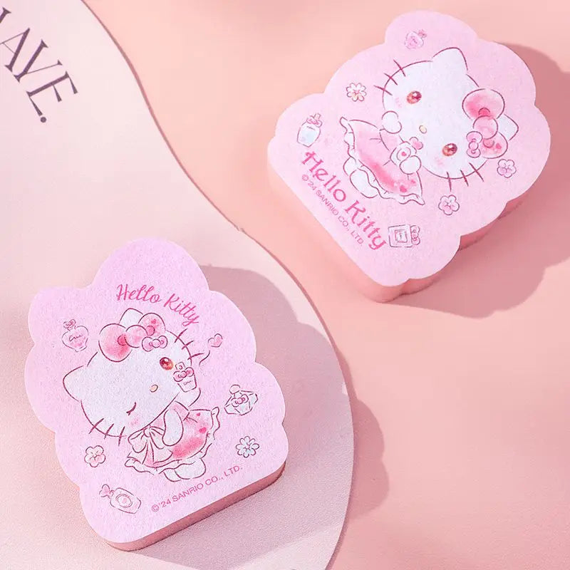 Two pink Hello Kitty kitcheen tool on a light pink background