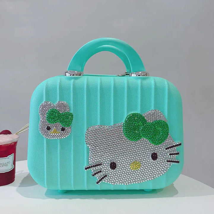 Turquoise cat-shaped makeup bag with rhinestone details on a white surface.