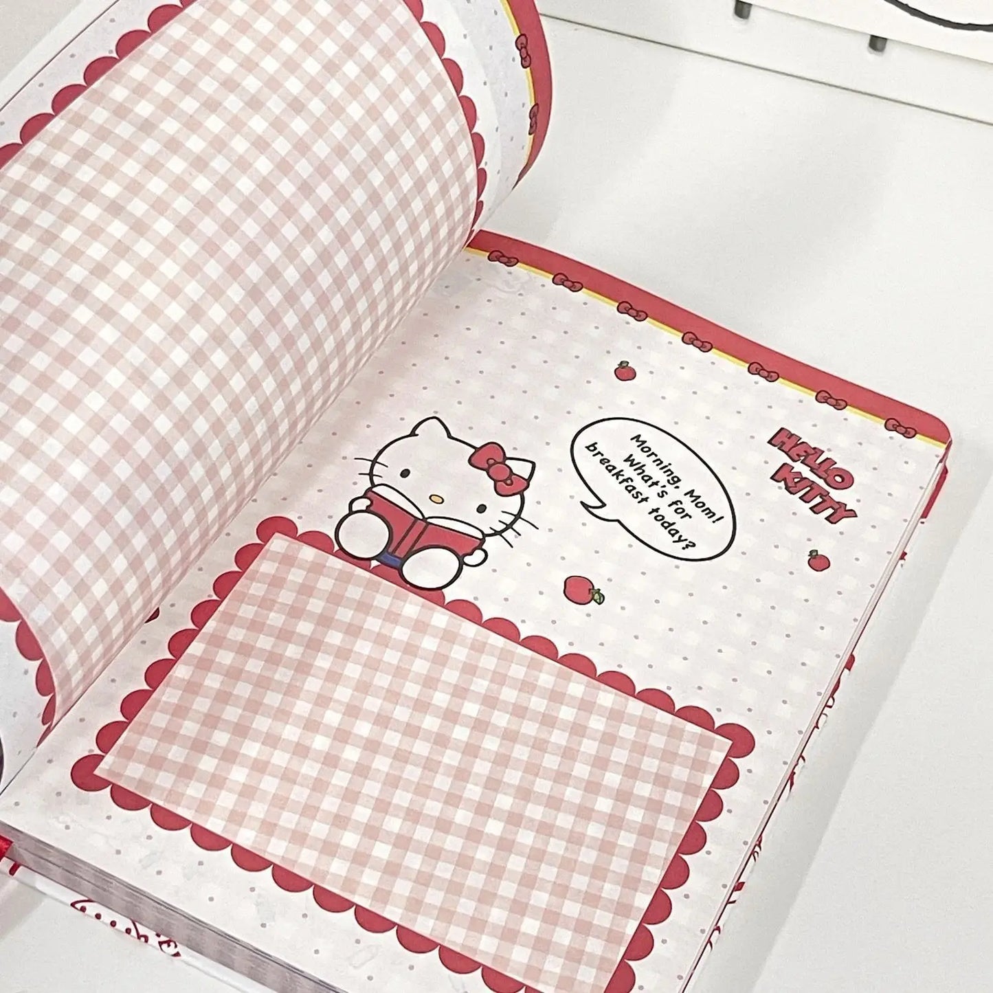 Open book with Hello Kitty design on a white background