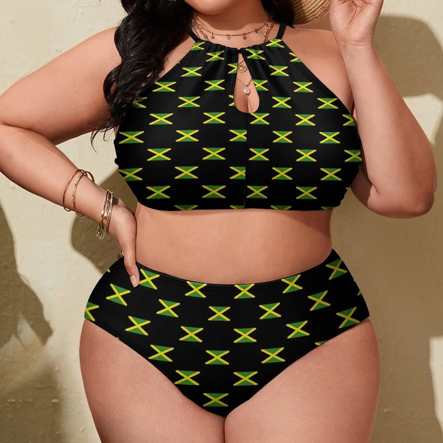 Person wearing a black bikini with green and yellow patterns, likely representing the Jamaican flag, against a neutral background.