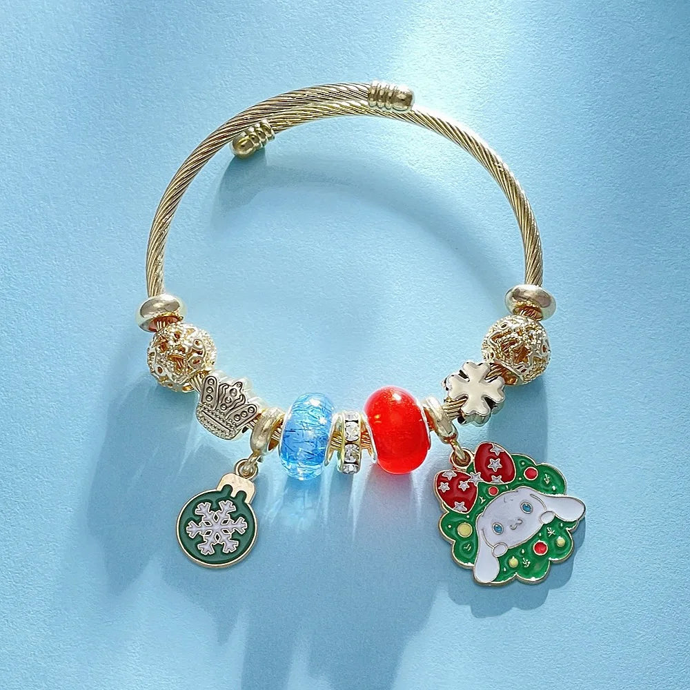 Gold bracelet with colorful charms on a light blue background
