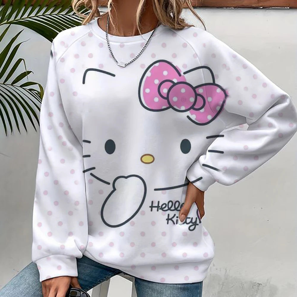White sweatshirt with Hello Kitty design worn by a person, against a neutral background.